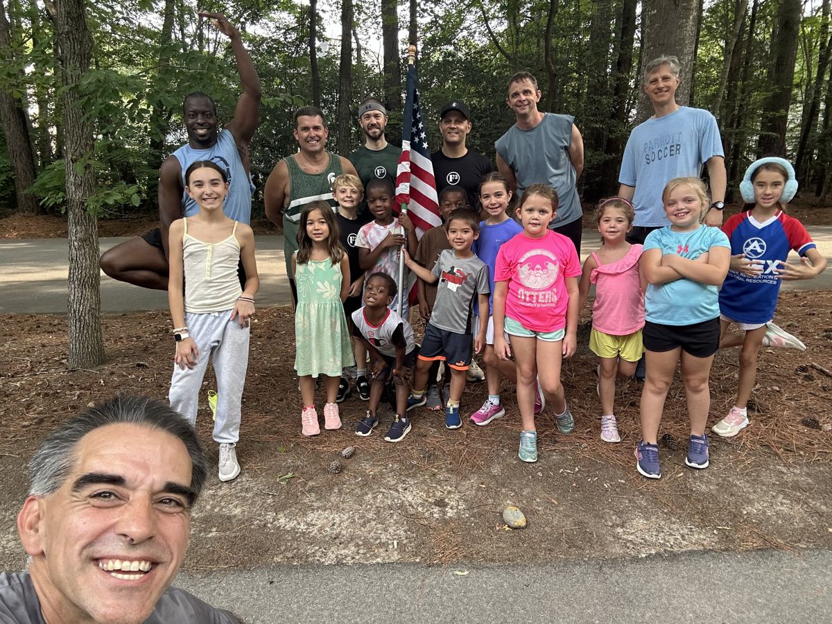 F3 men and their kids posing with an American flag