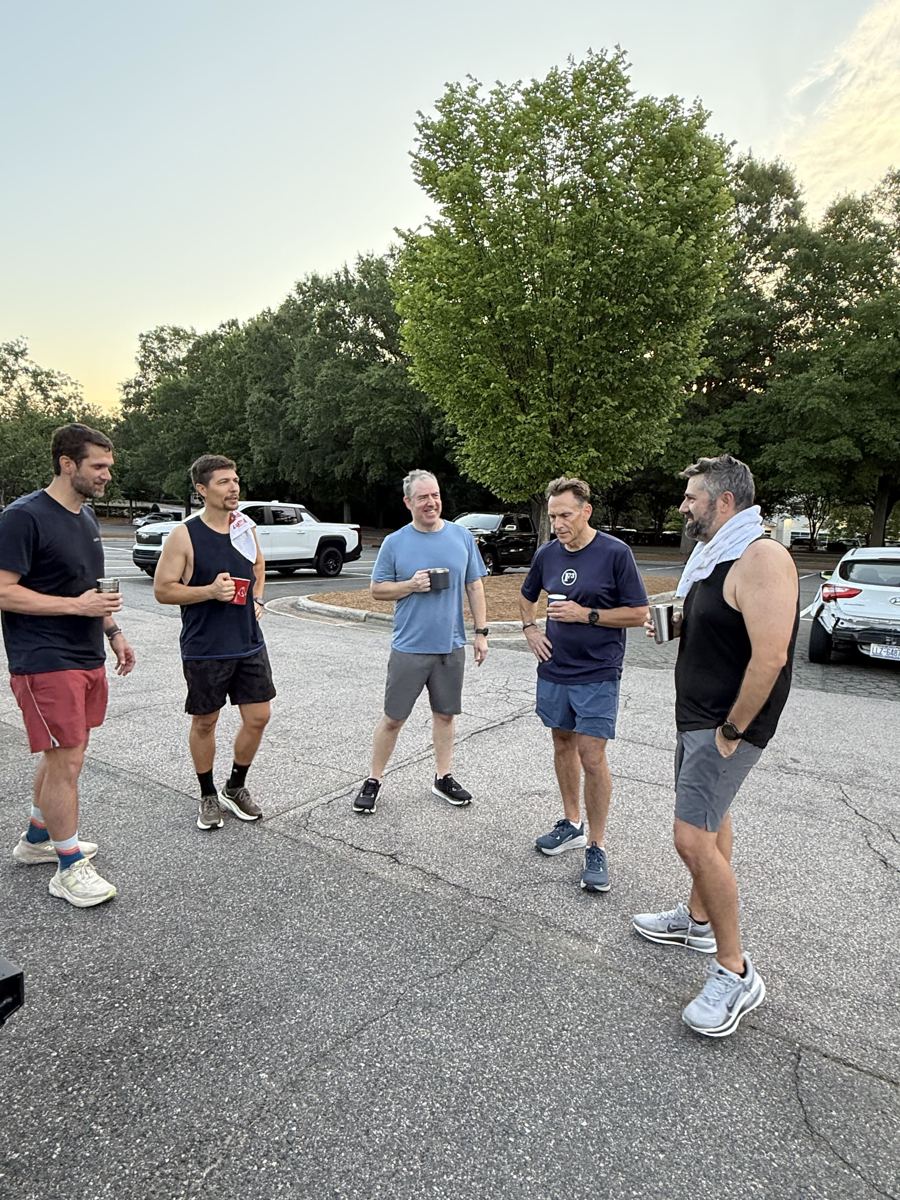Five F3 South Cary men talking over coffee in a parking lot after a workout